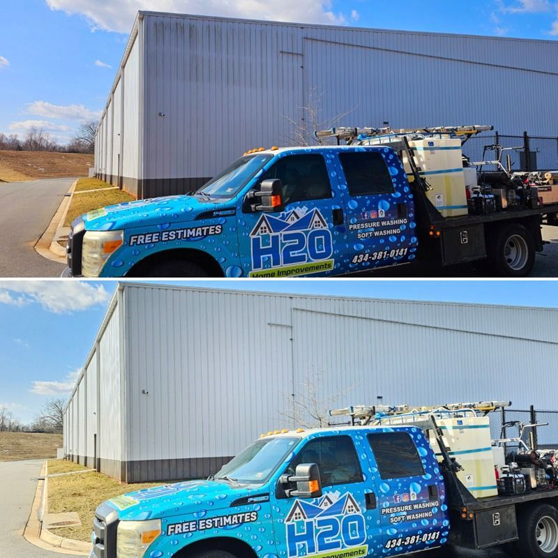 Blue H2O service truck parked beside a large white warehouse on a sunny day