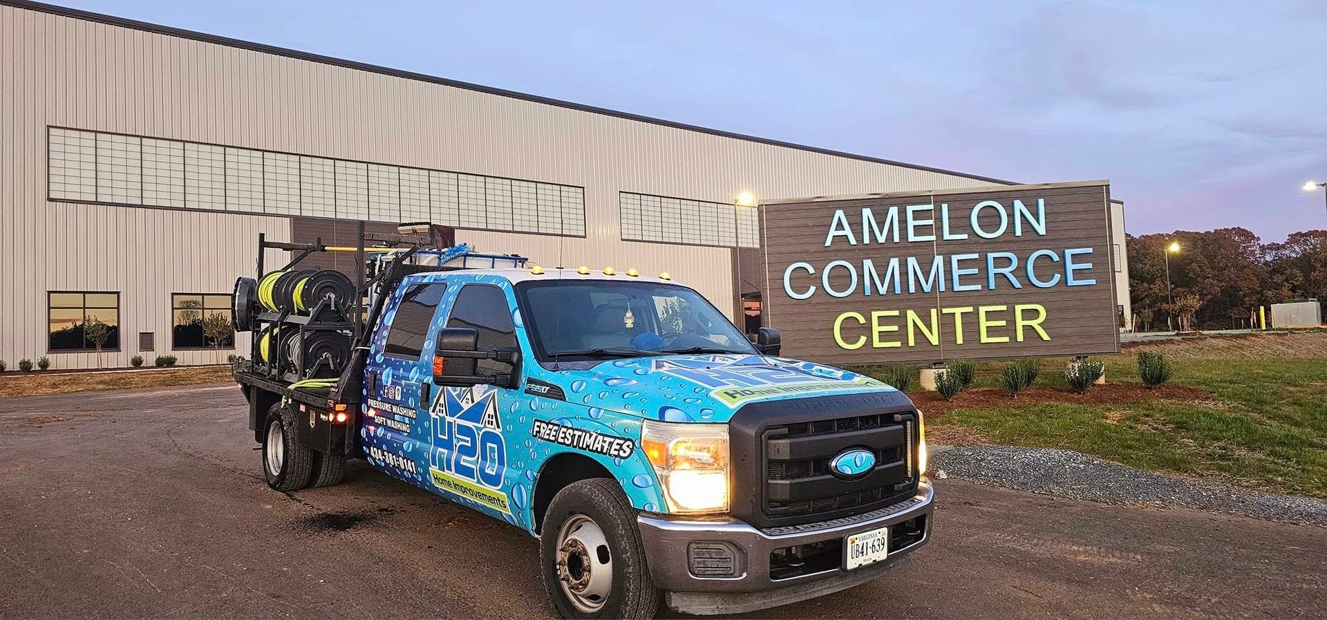 Blue tow truck parked in front of the Amlon Commerce Center building