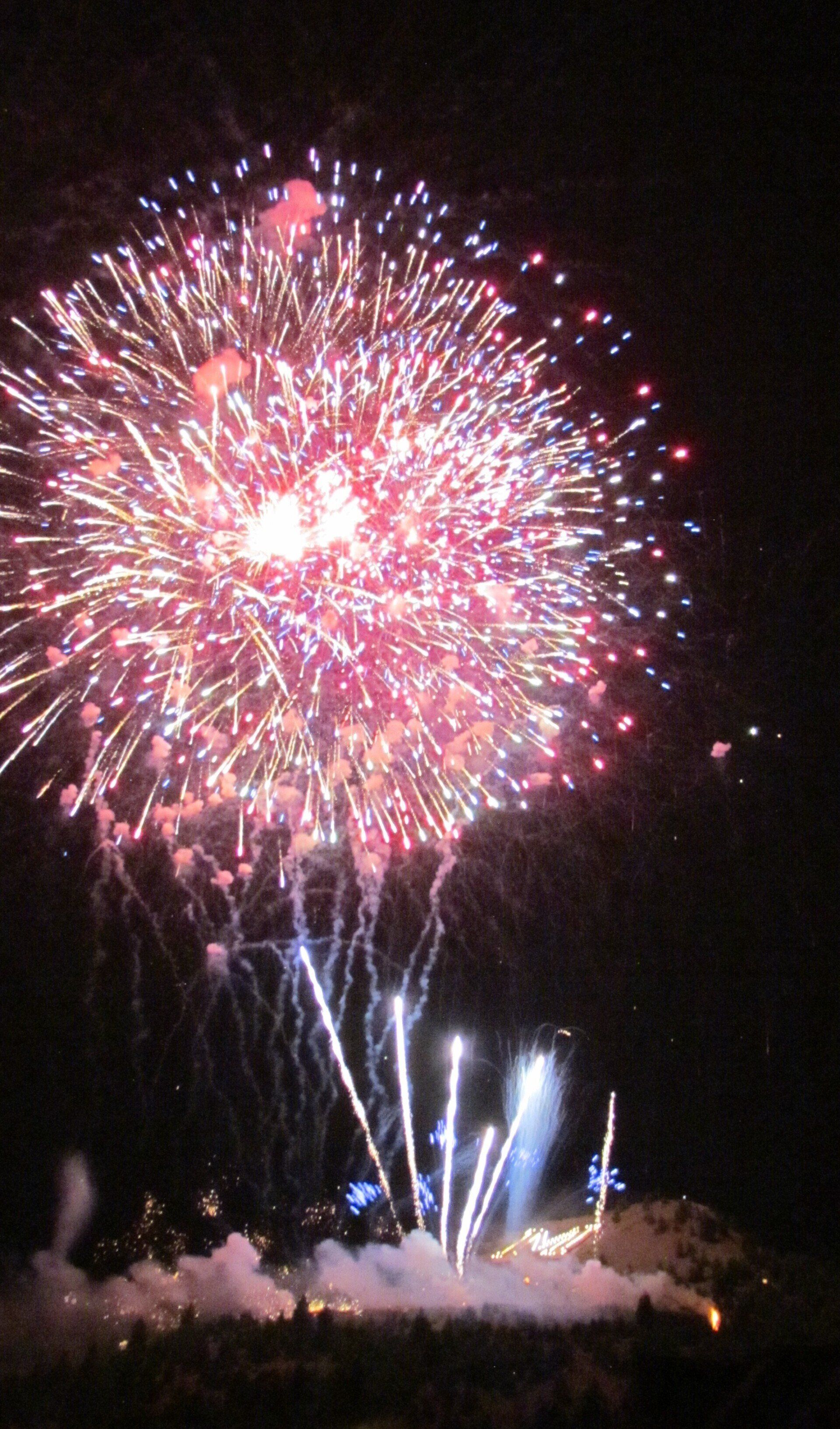 Fireworks exploding in the night sky over  Butte, MT