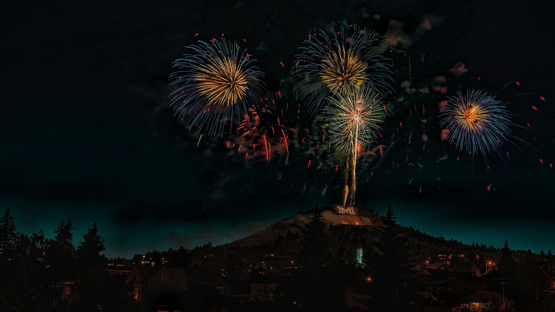 Fireworks exploding in the night sky over Butte, MT
