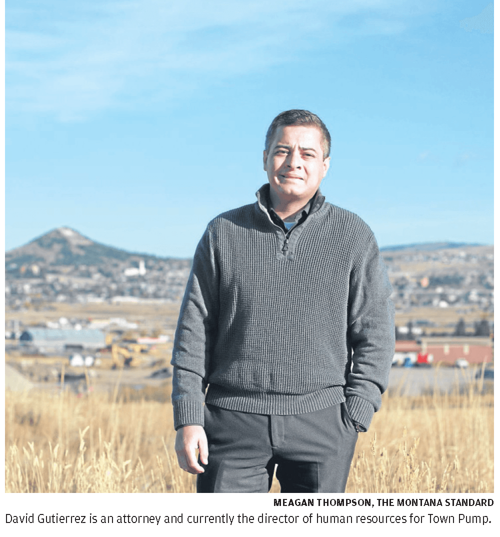 Photo of David Gutierrez standing outside with the Butte M behind him in the distance