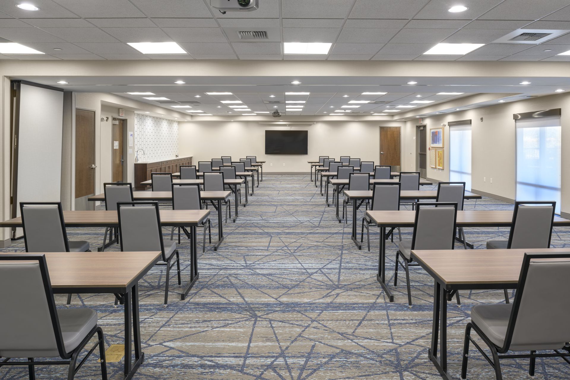 A large conference room filled with tables and chairs.