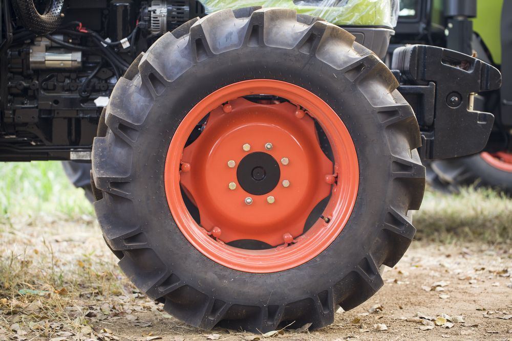 A Close Up of a Tractor Tire on a Dirt Road — Docs Mobile Tyre Service In Kawana, QLD