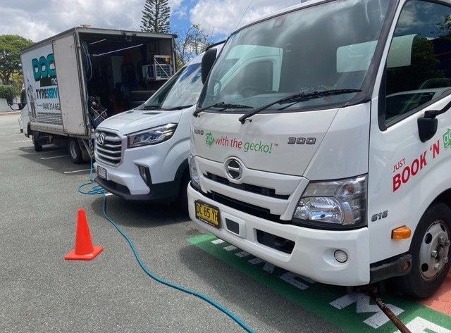 Two White Trucks Are Parked Next To Each Other In A Parking Lot — Docs Mobile Tyre Service in Hervey Bay, QLD