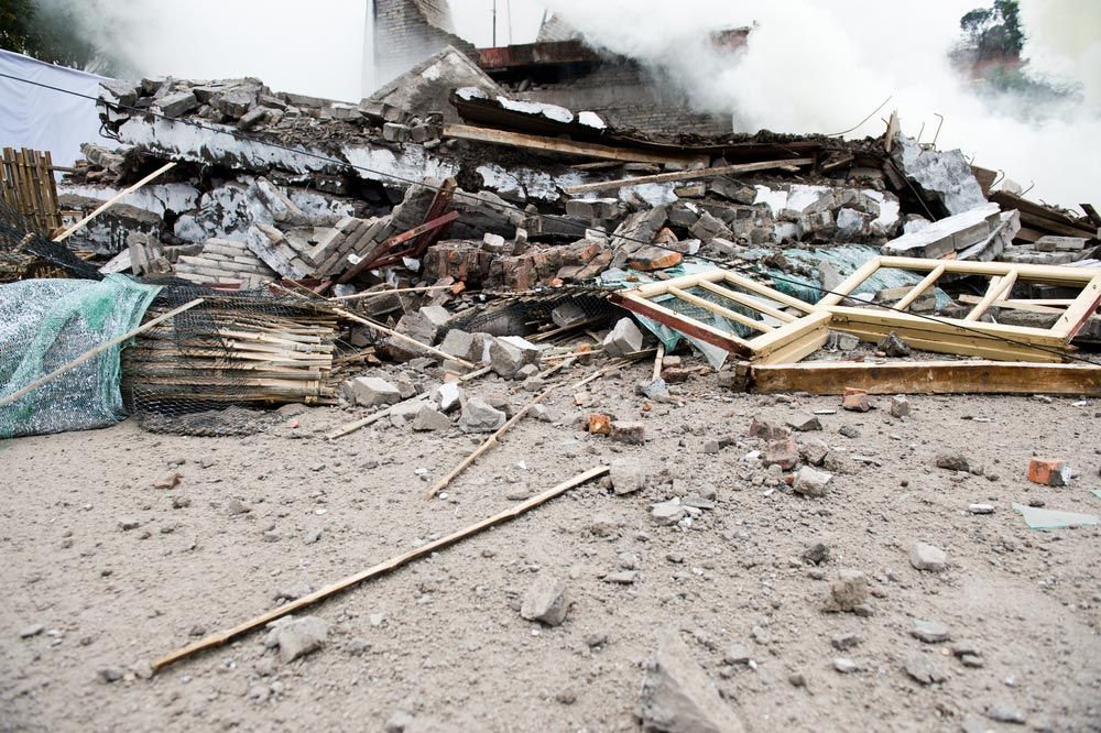 A Pile Of Rubble Is Sitting On The Ground In Front Of A Building — Ballina Demolitions In East Wardell, NSW