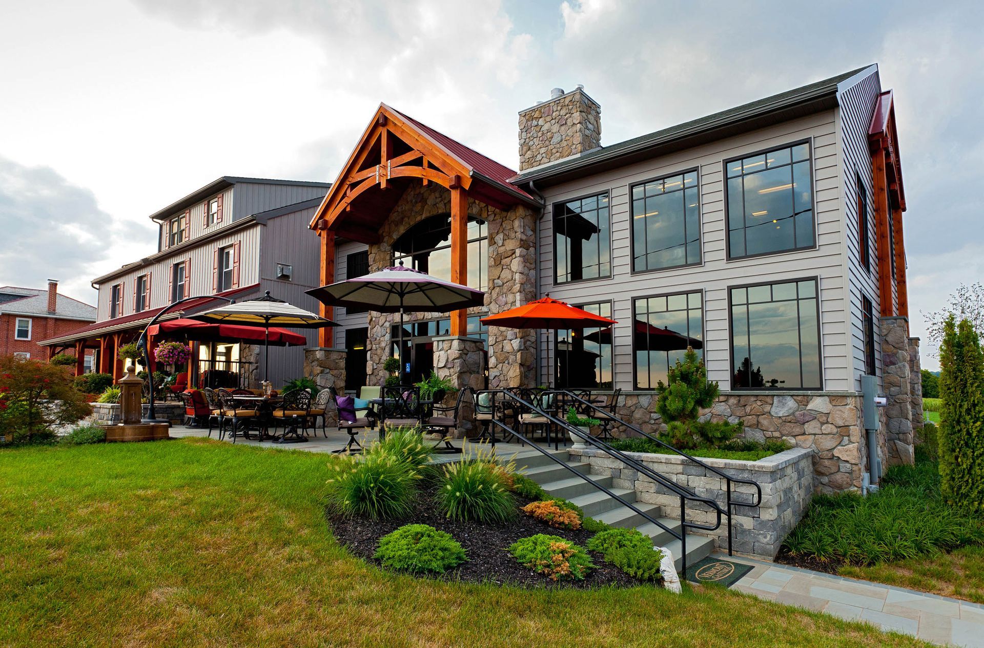 A large building with a lot of windows and umbrellas in front of it