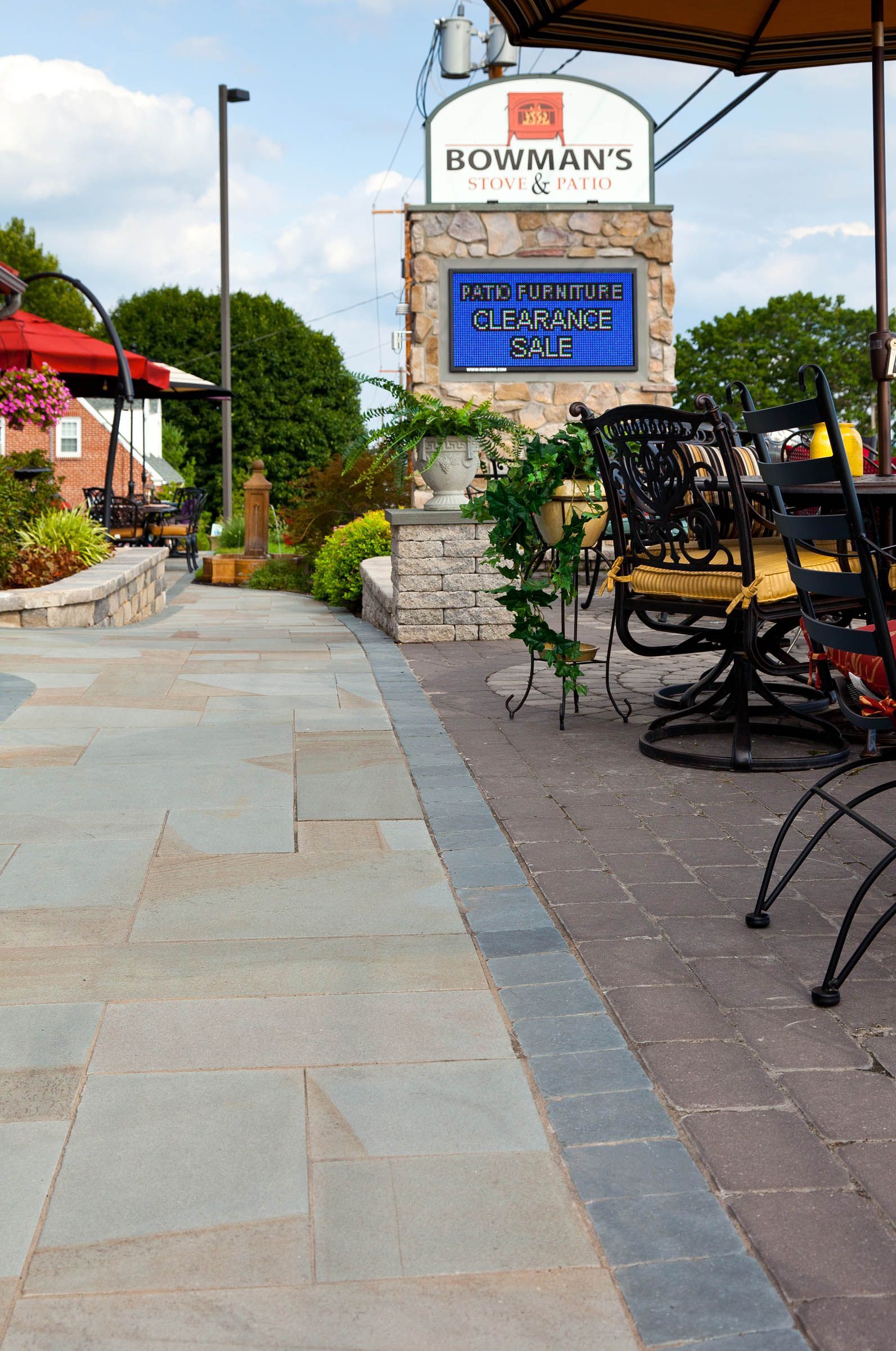 A patio with tables and chairs and a sign that says boatman 's