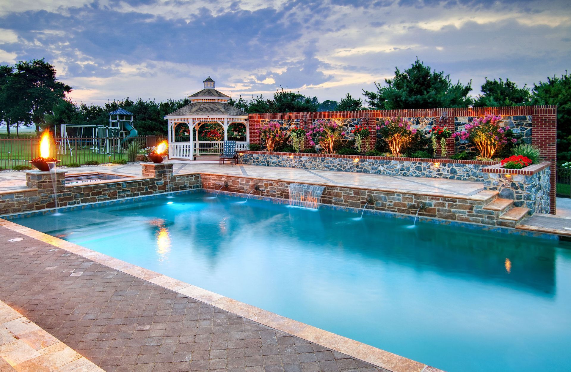 A large swimming pool with a gazebo in the background