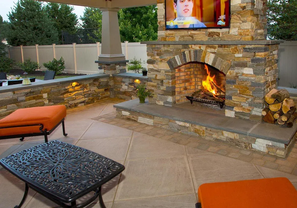 A stone fireplace with a flat screen tv above it