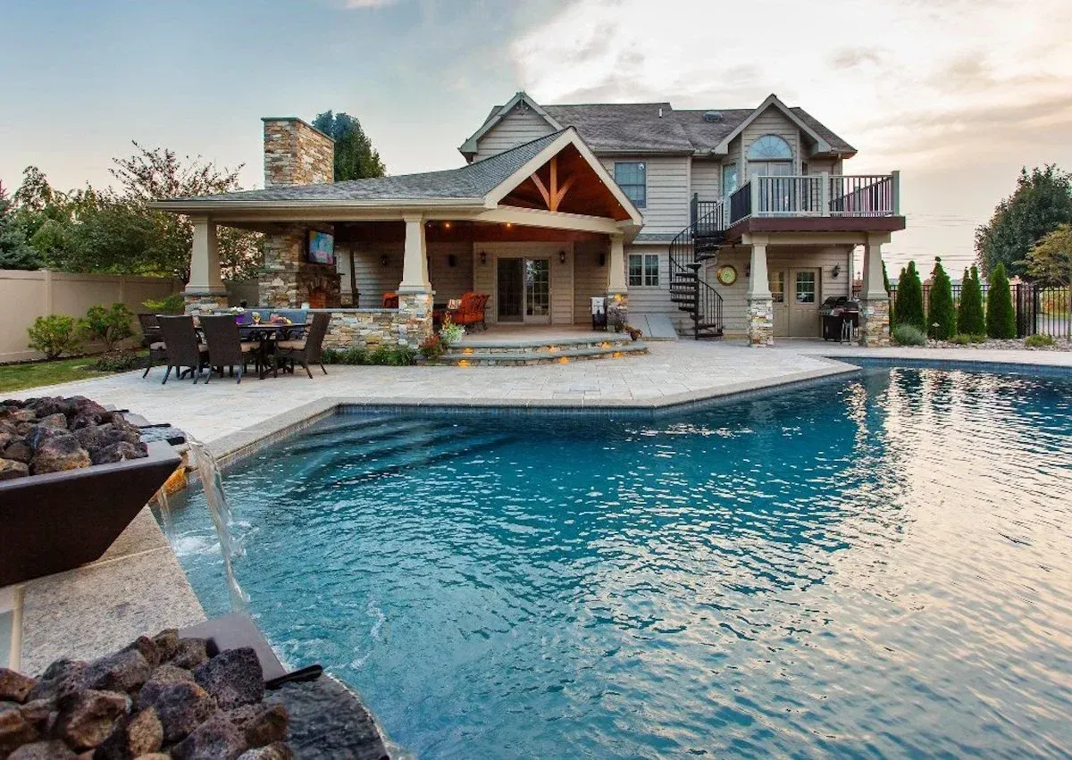 A large house with a large swimming pool in front of it.
