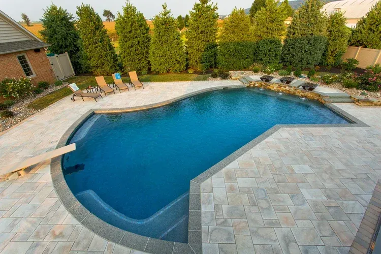 An aerial view of a large swimming pool in a backyard