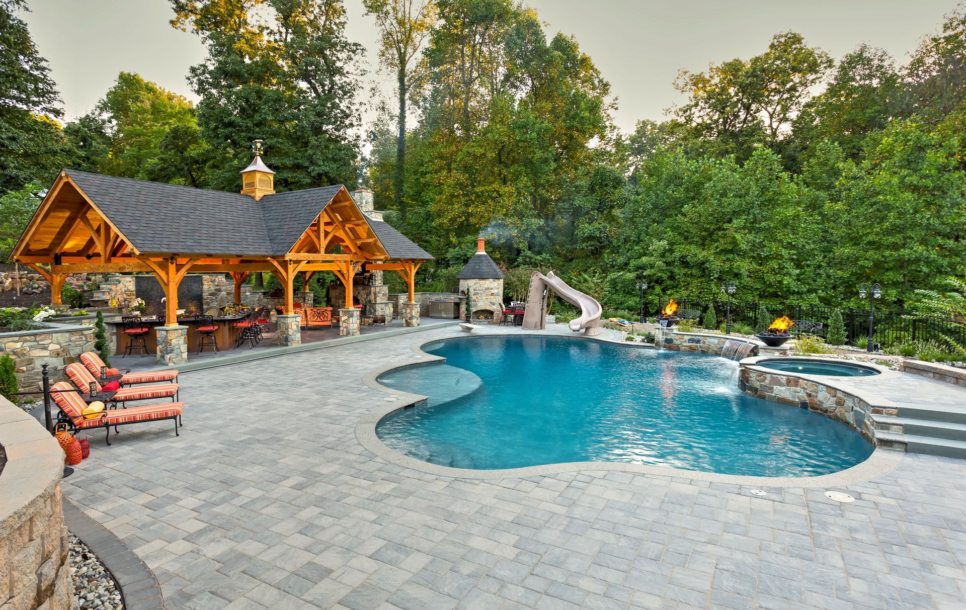A large swimming pool with a gazebo in the background