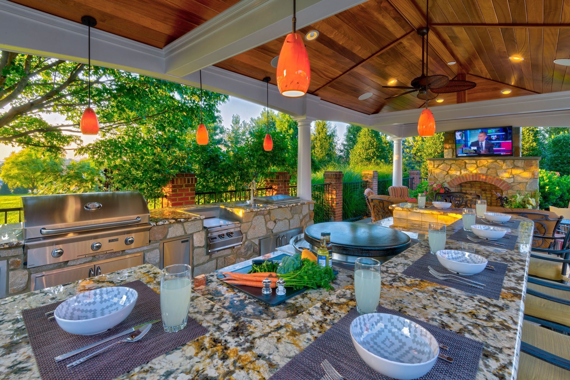 There is a table with plates and bowls on it in the backyard.