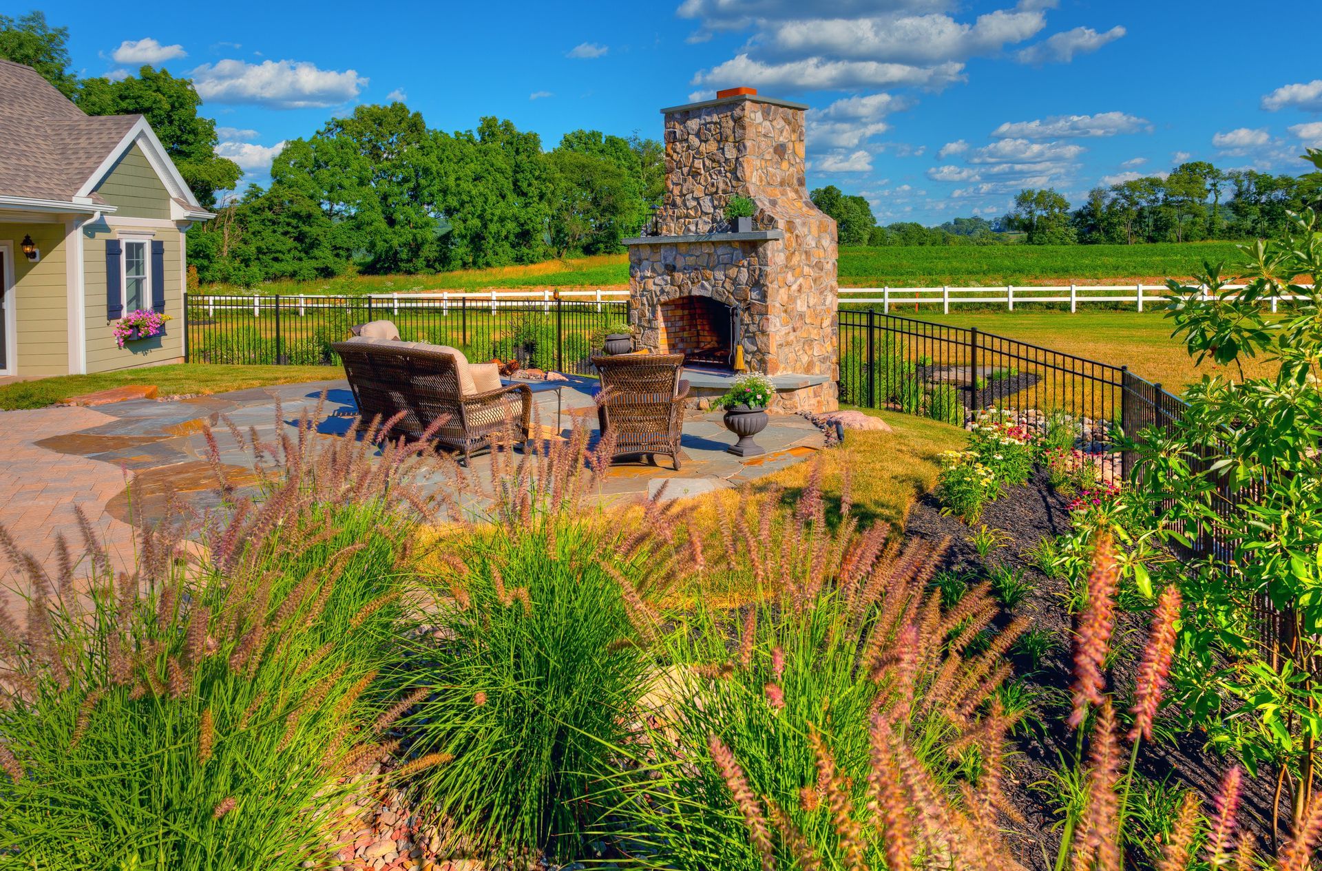 There is a fireplace in the backyard of a house.