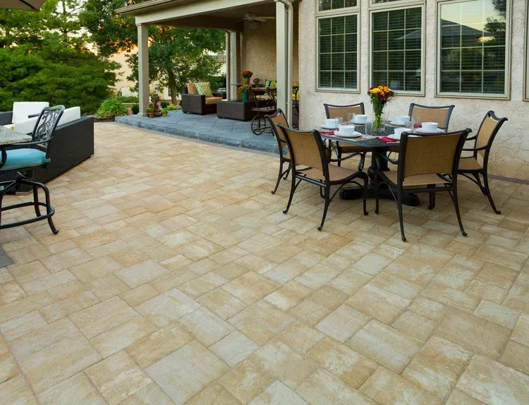 A patio with a table and chairs on it