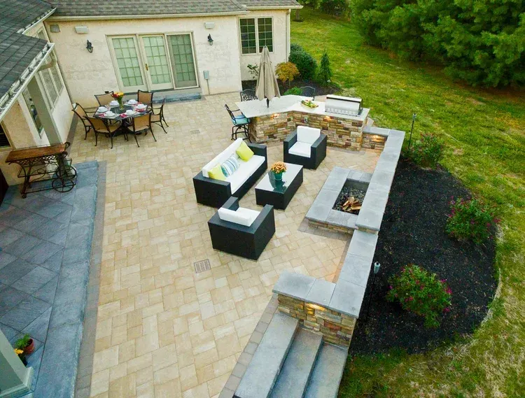 An aerial view of a patio with furniture and a fire pit.