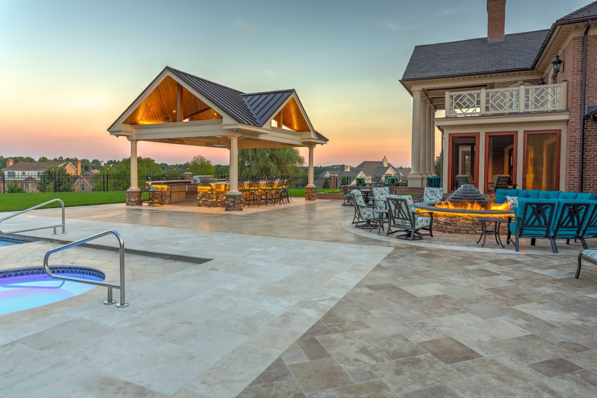 There is a large swimming pool in the backyard of a house.