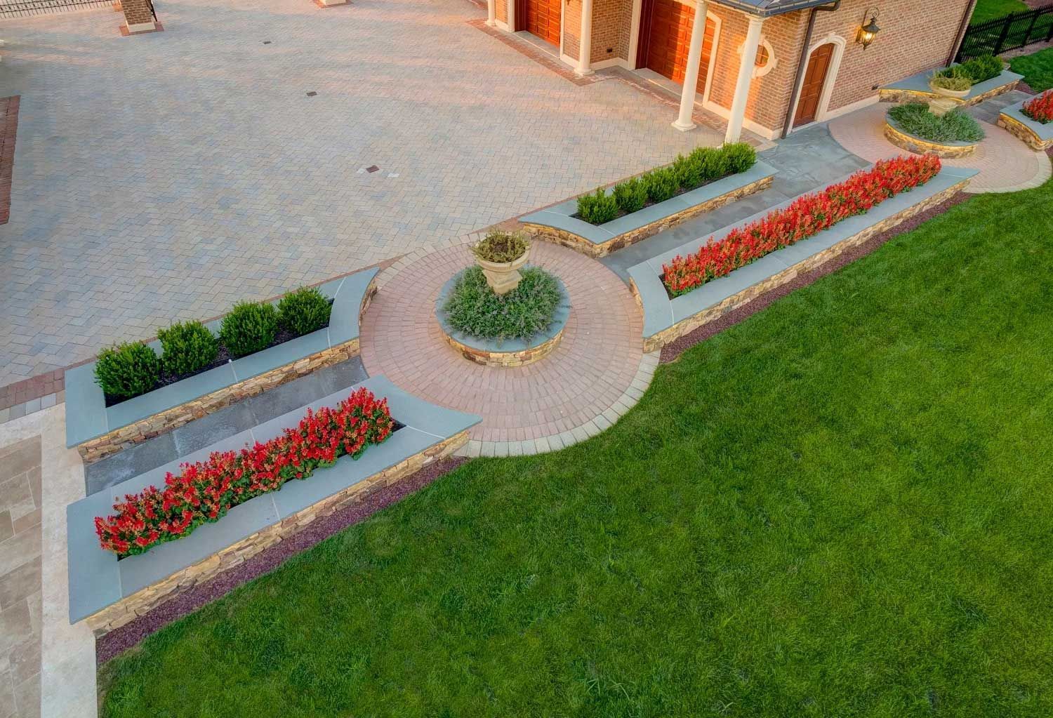 An aerial view of a lush green lawn in front of a house.
