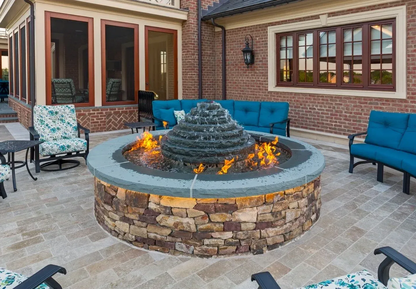 There is a fire pit in the middle of the patio.
