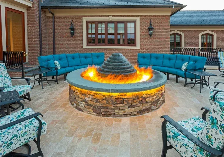 There is a fire pit in the middle of the patio.
