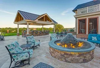 There is a fire pit in the middle of the patio.