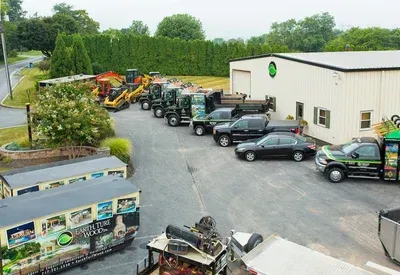 A row of trucks are parked in front of a building.