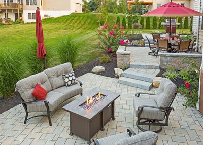 There is a fire pit in the middle of the patio.