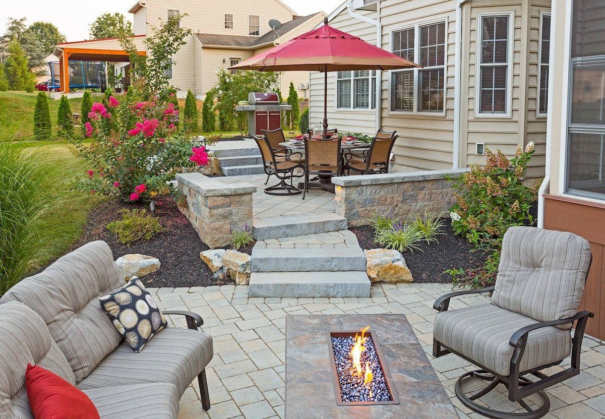 There is a fire pit in the middle of the patio.