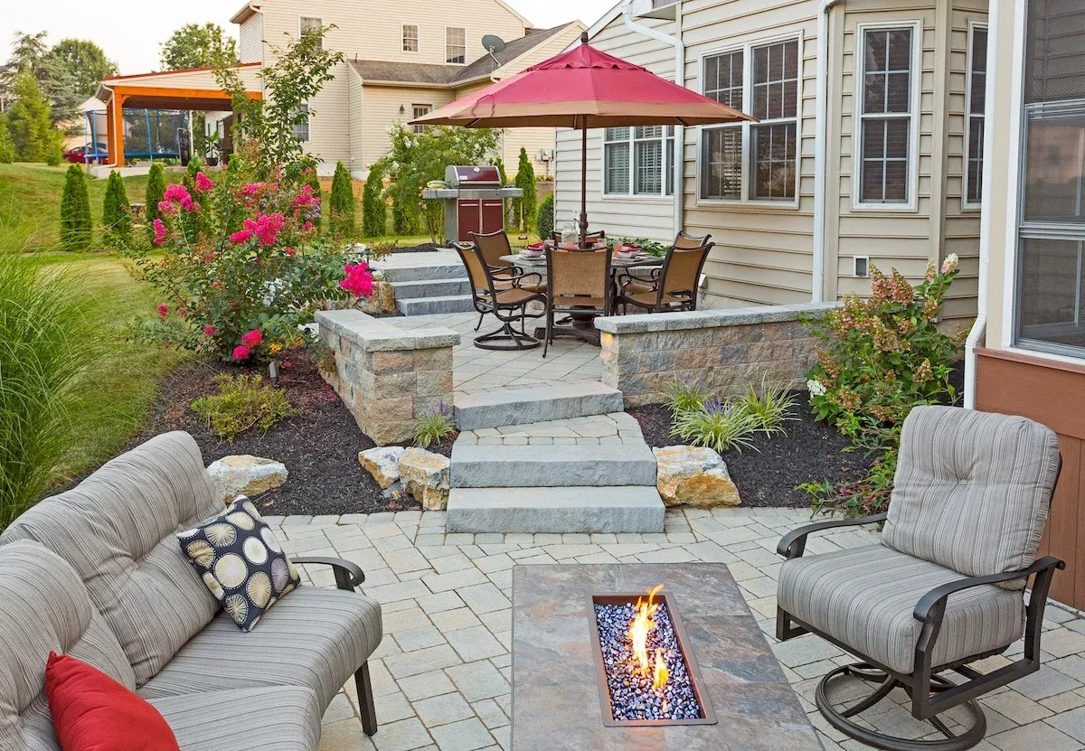 There is a fire pit in the middle of the patio.