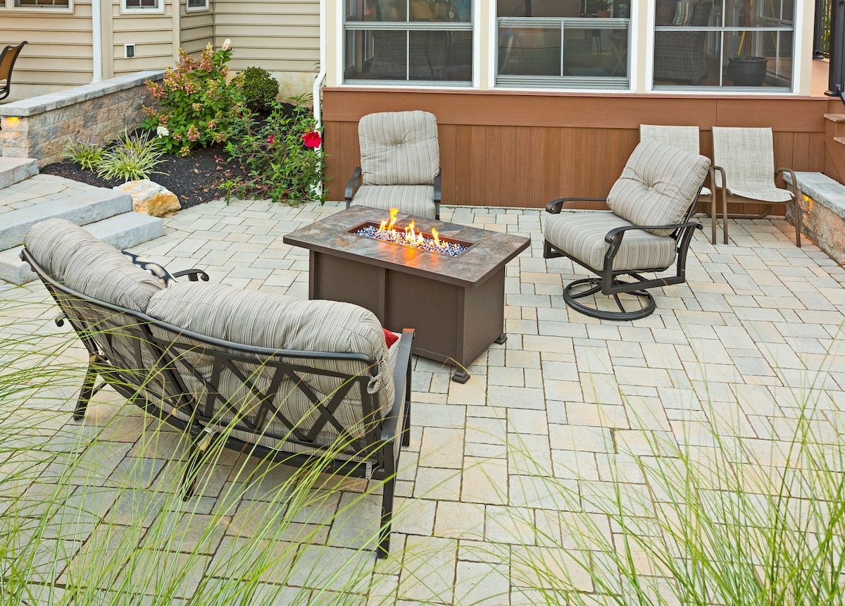 There is a fire pit in the middle of the patio.