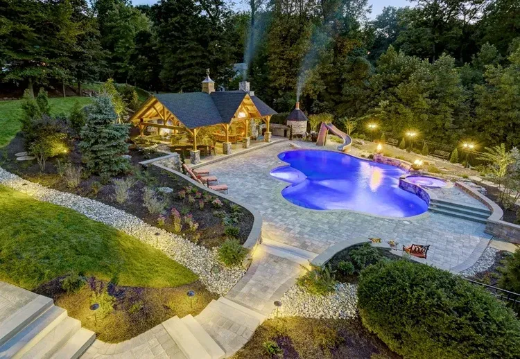 An aerial view of a large swimming pool in a backyard