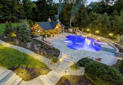 An aerial view of a large swimming pool in a backyard