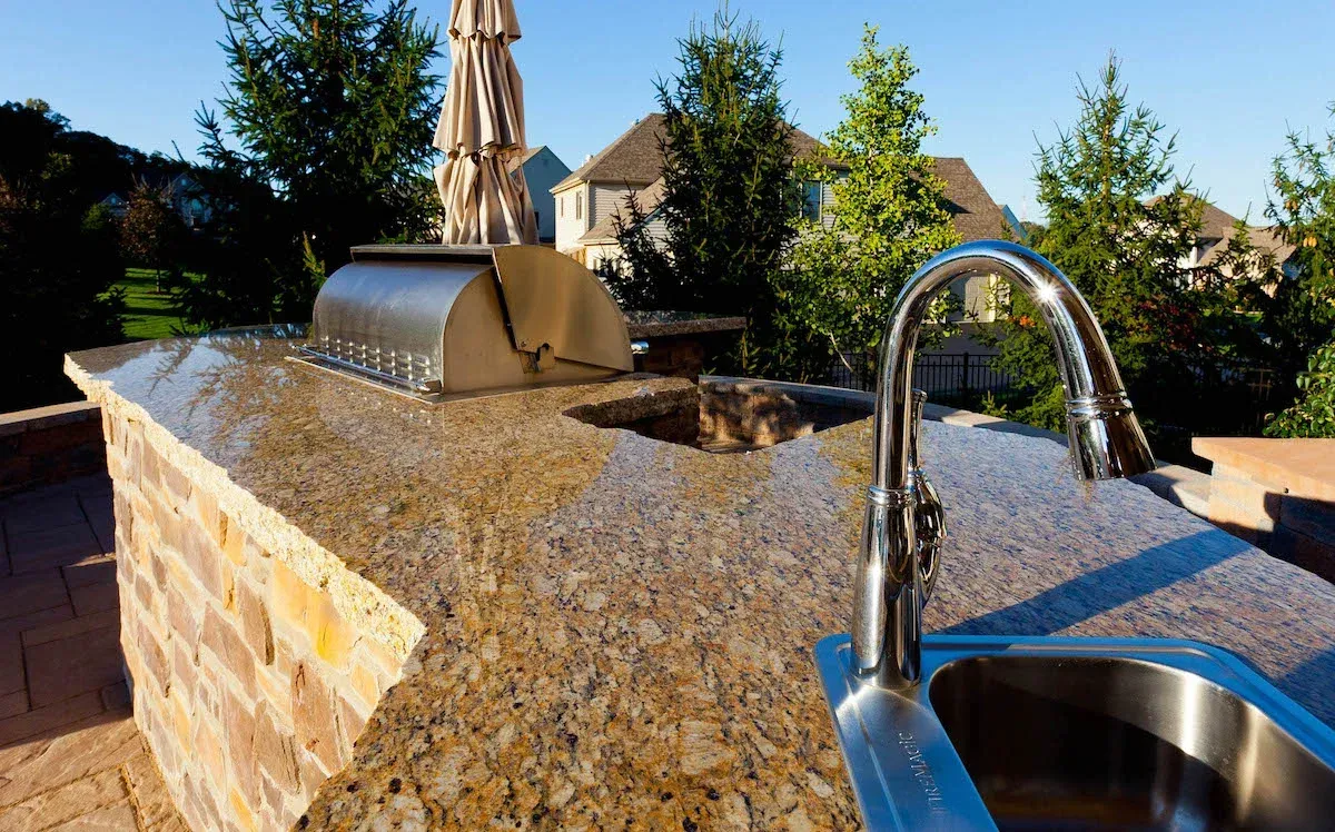 A stainless steel sink is sitting on top of a granite counter top.