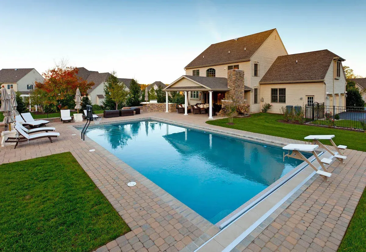 A large swimming pool in the backyard of a house