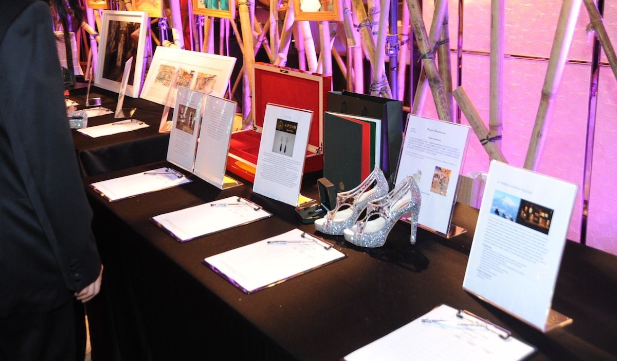 A table with a lot of items on it including shoes