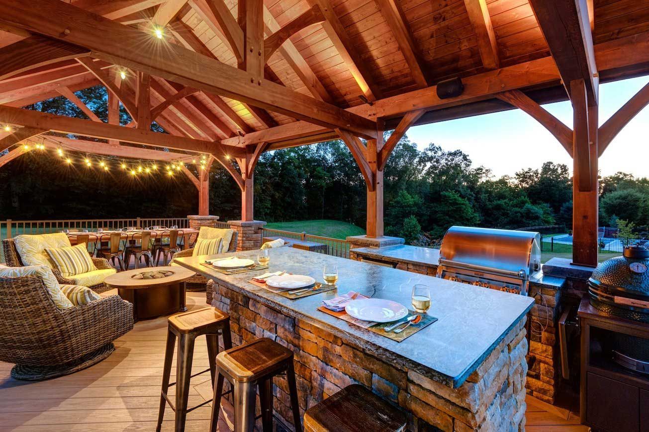 A large covered patio with a bar and a grill.