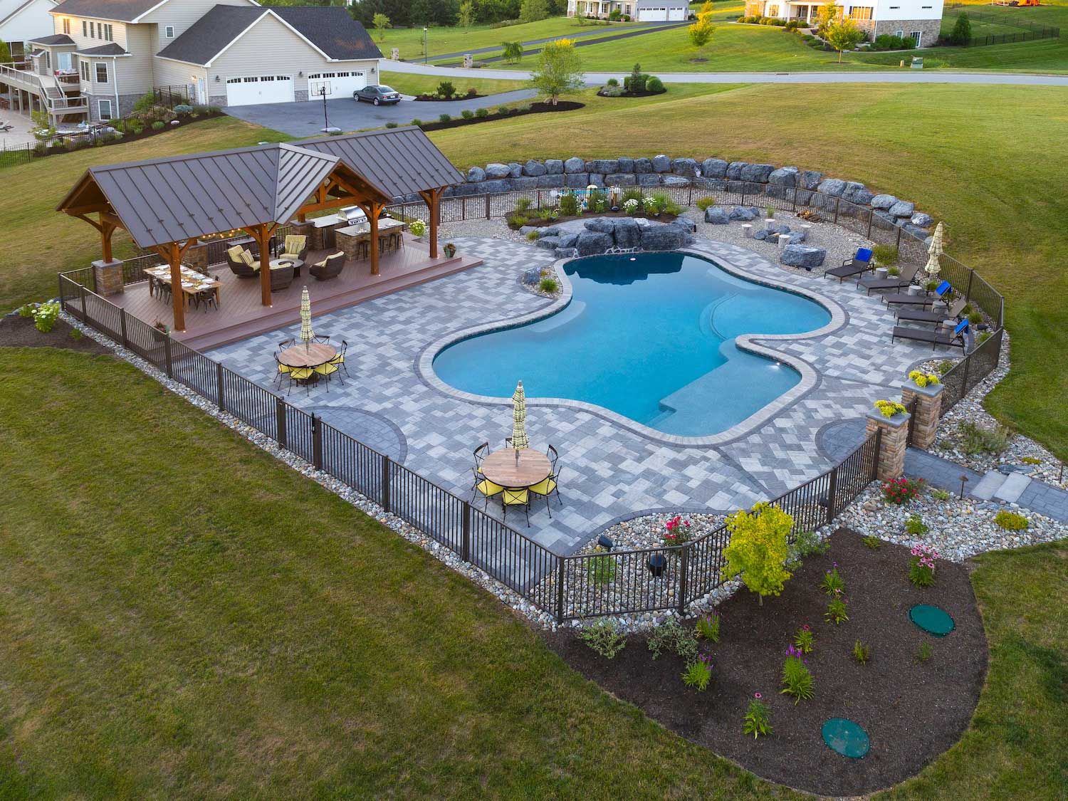 An aerial view of a large swimming pool surrounded by a fence.