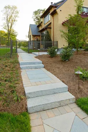 A walkway with stairs leading to a house
