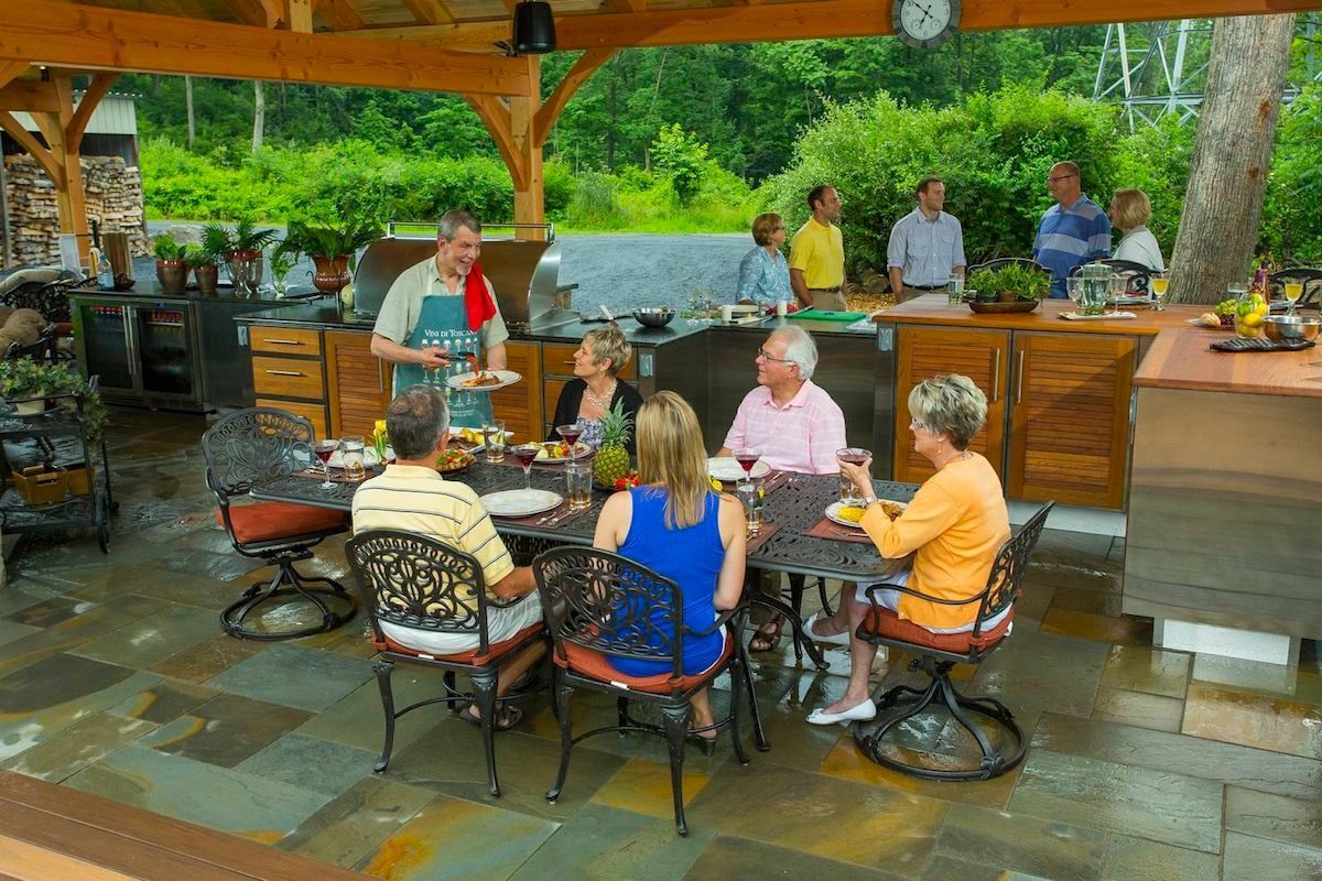 A group of people are sitting around a table eating food.