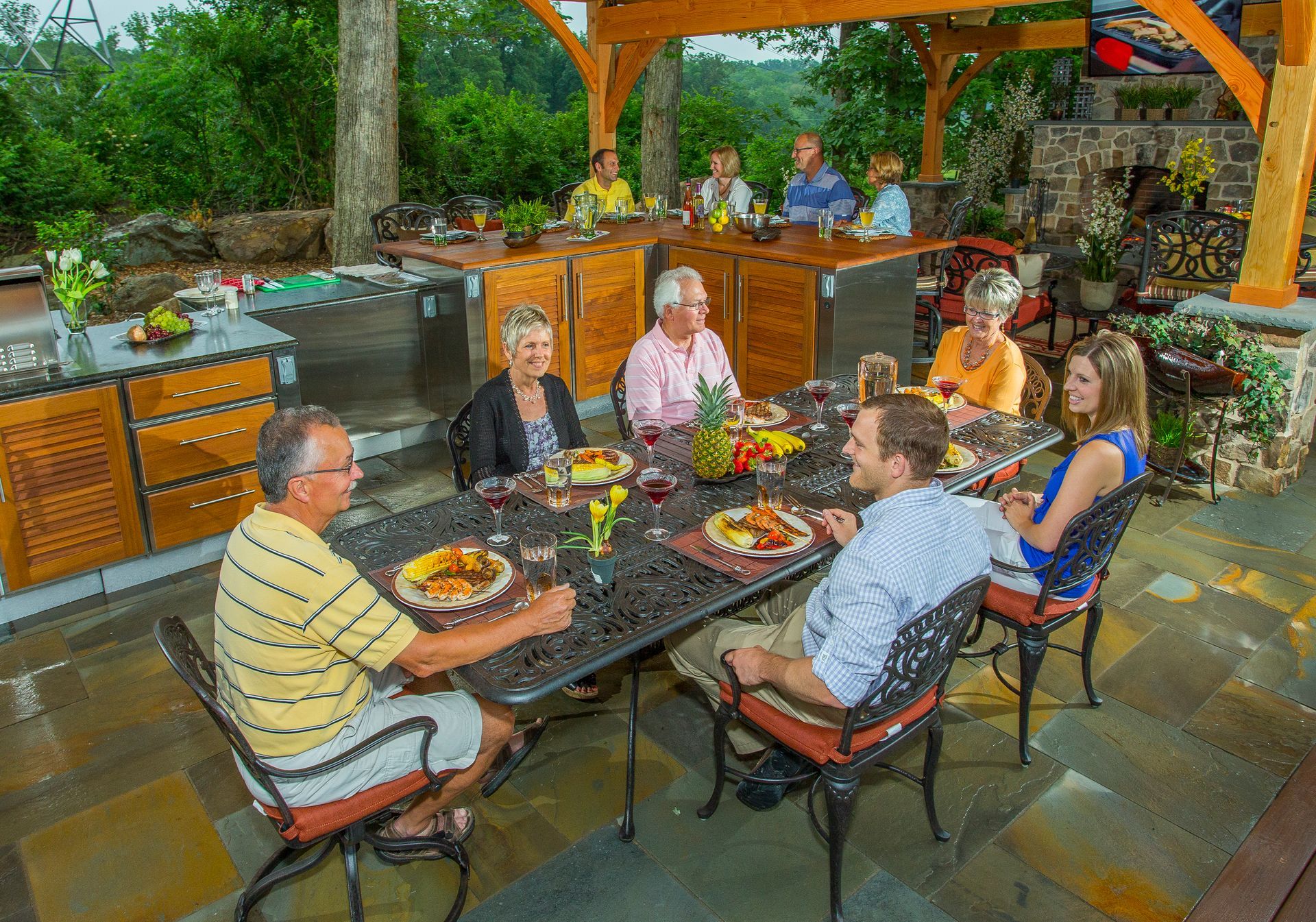 A group of people are sitting around a table eating food. A group of people are sitting around a table eating food.