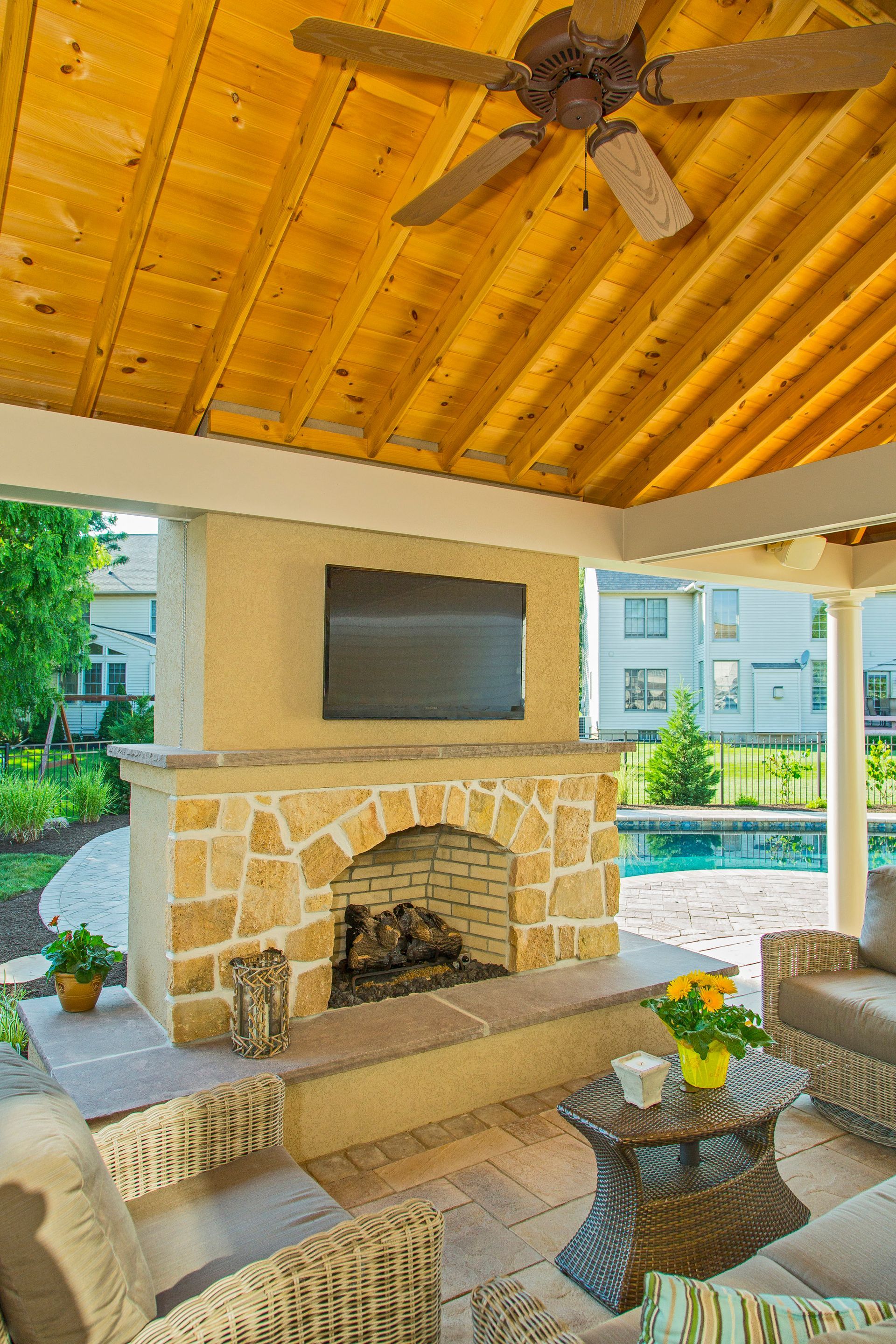 A living room with a fireplace and a television on the wall.