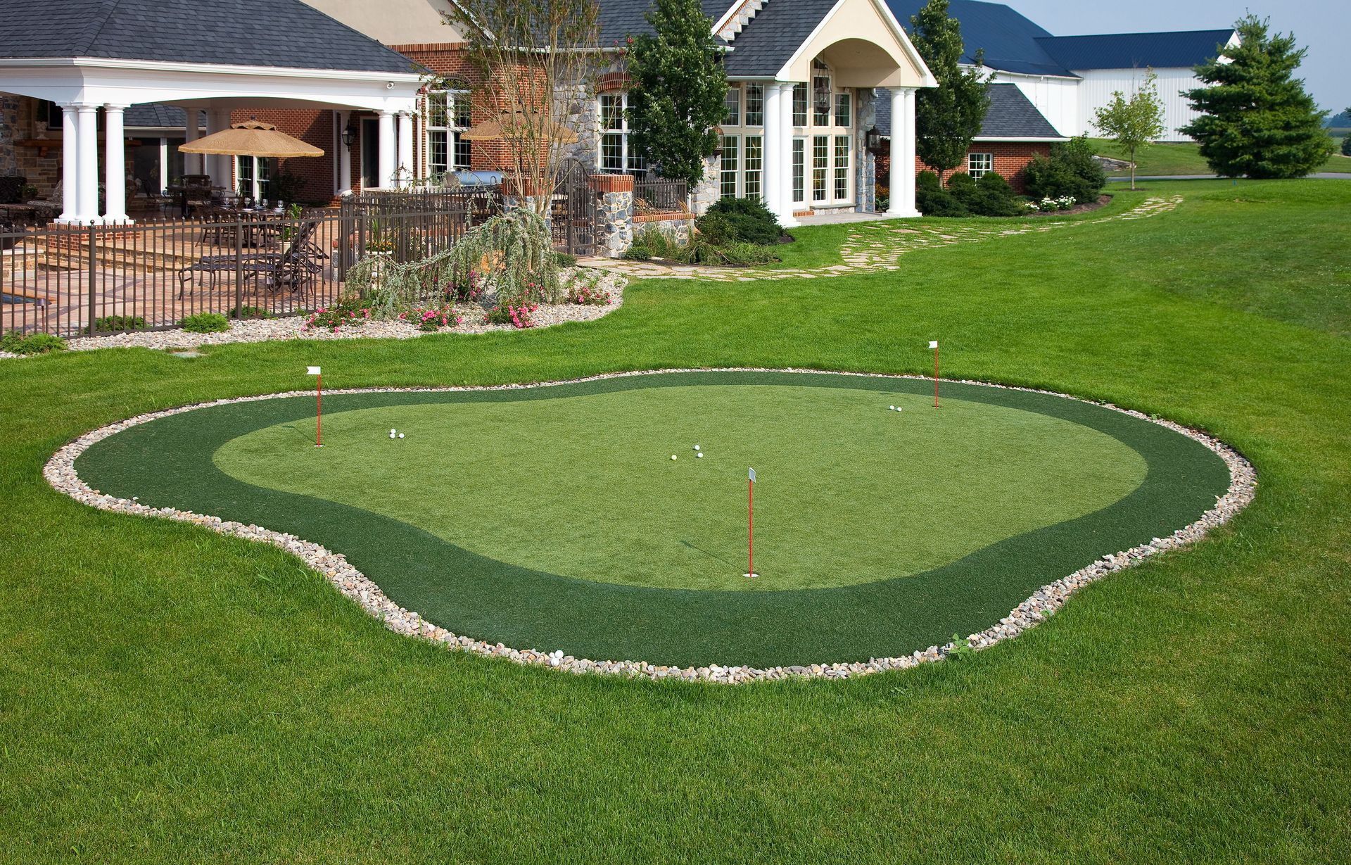 A house with a putting green in front of it