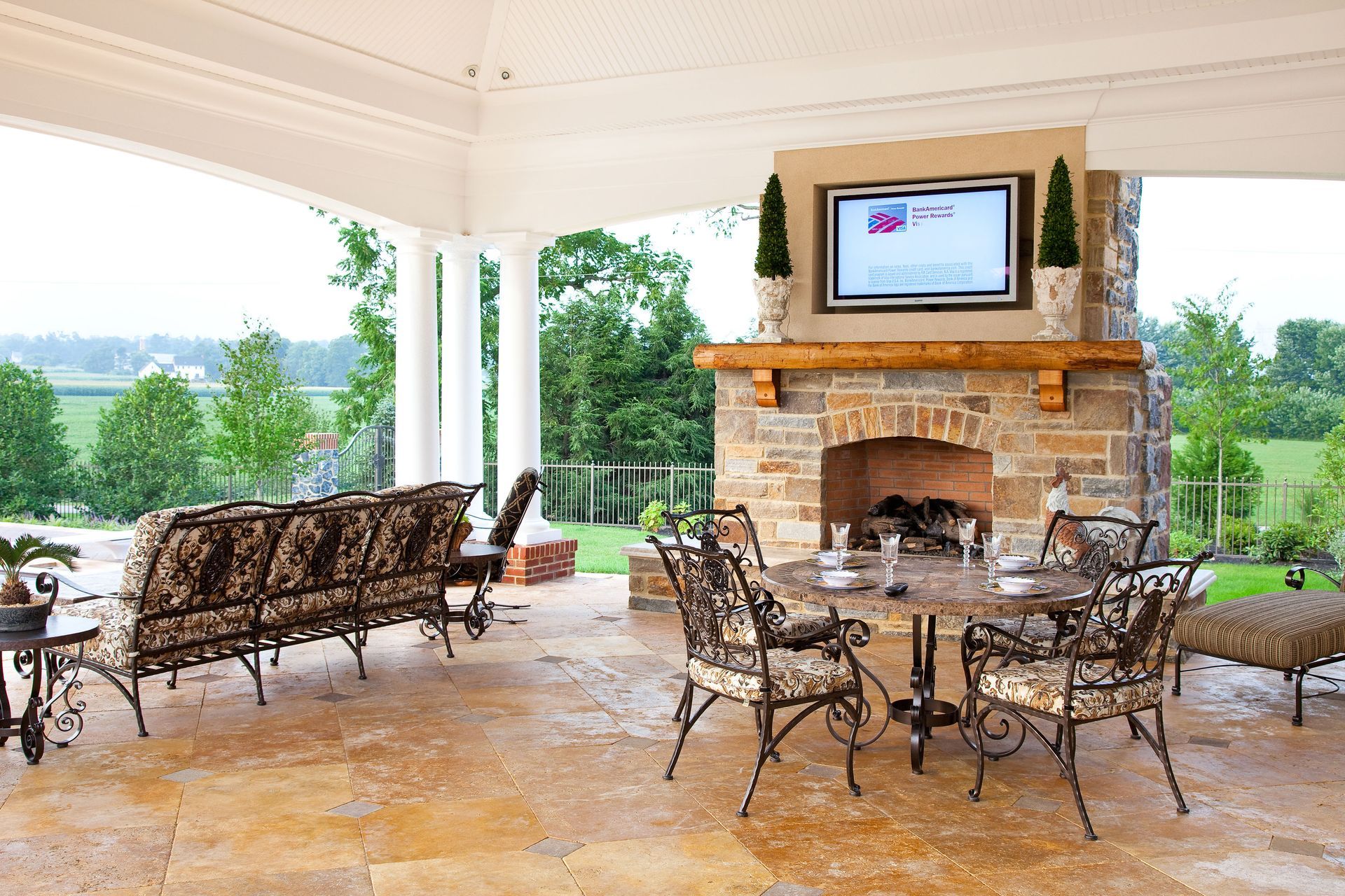 A patio with a fireplace and a flat screen tv