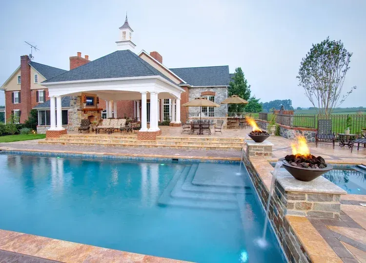 A large house with a large swimming pool in front of it