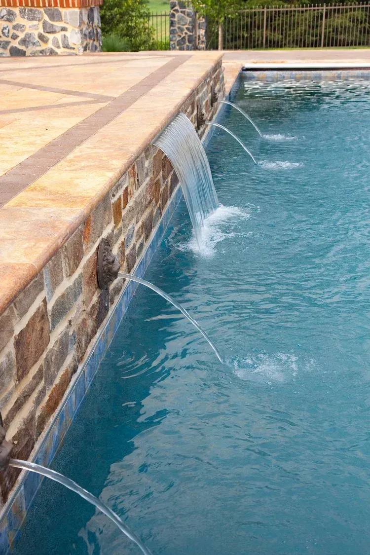 There is a waterfall in the middle of the pool.