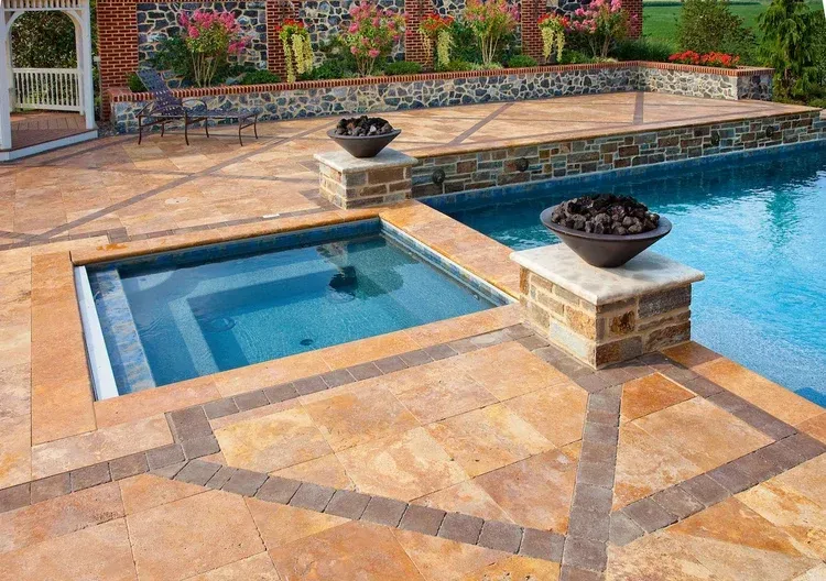 A large swimming pool with a hot tub in the middle of it.