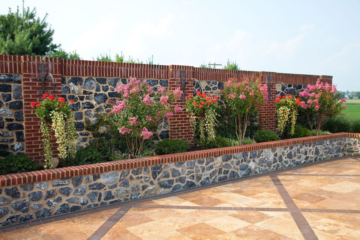A stone wall with flowers growing on it