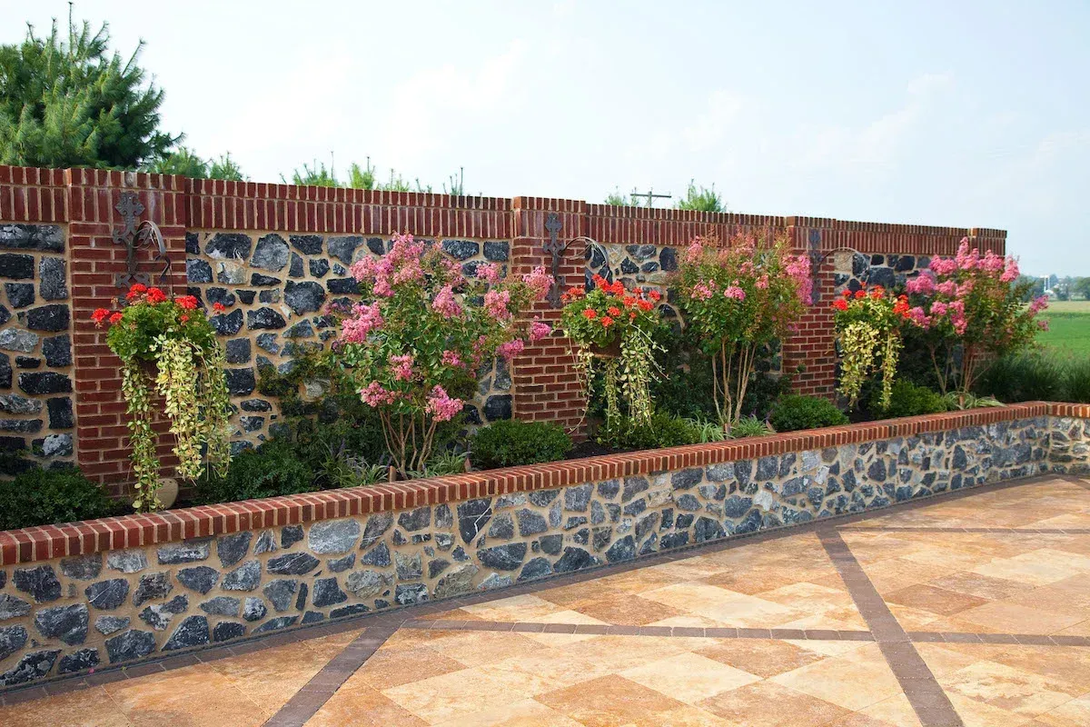 A stone wall with flowers growing on it