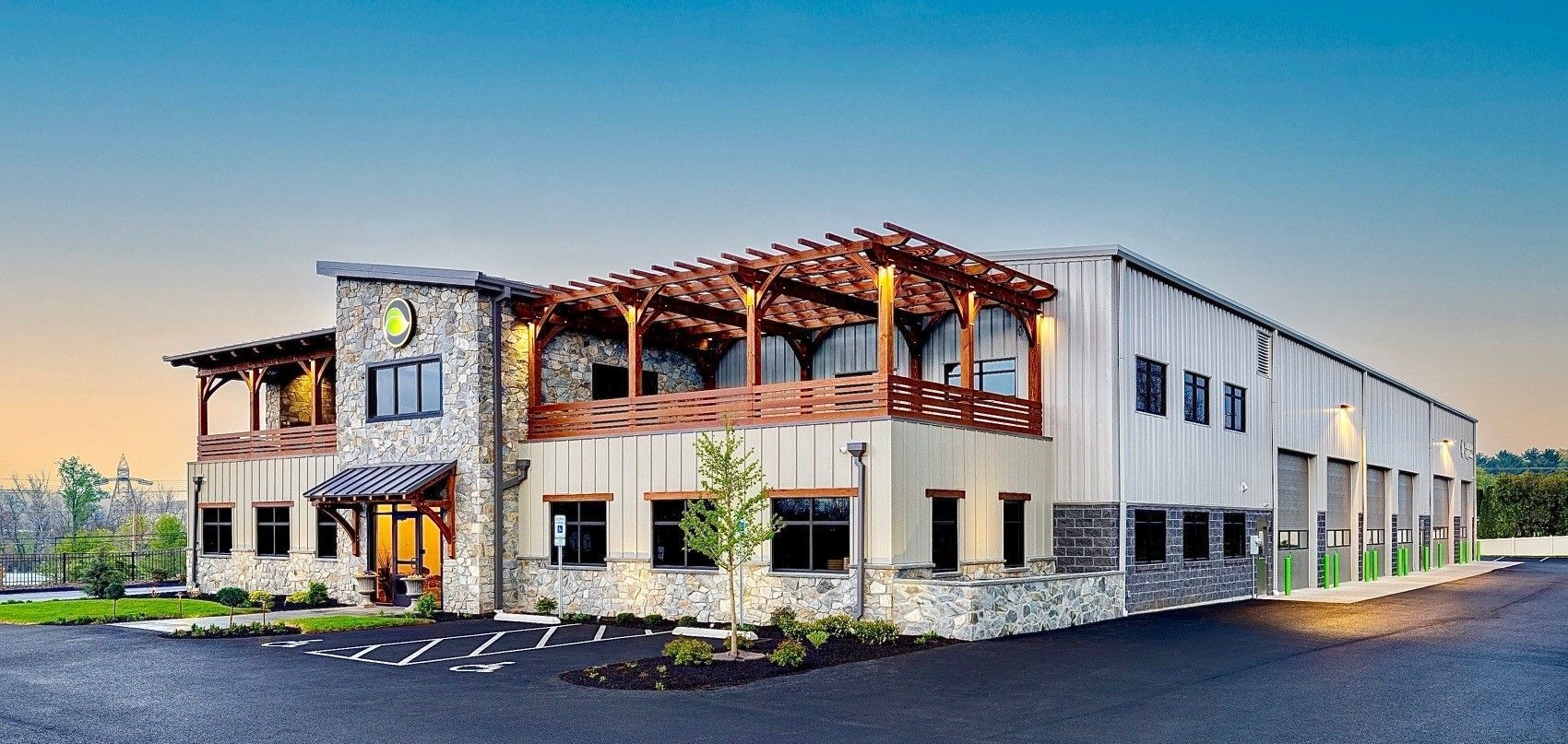 A large building with a lot of windows and a pergola on top of it. A large building with a lot of windows and a pergola on top of it.