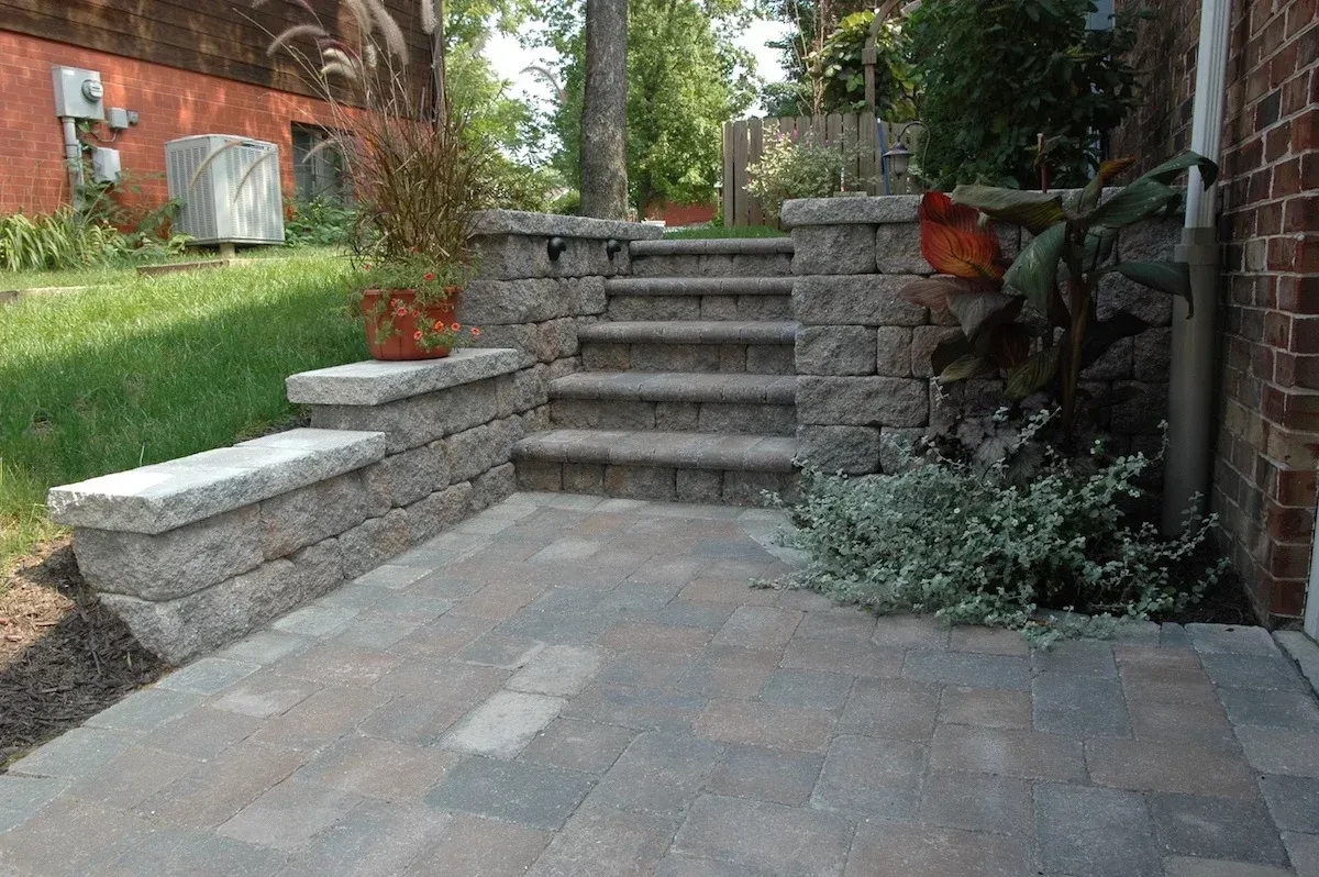 A stone walkway with stairs leading up to a house.